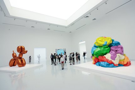 Visitors inside the galleries of the exhibition Jeff Koons: Lost In America