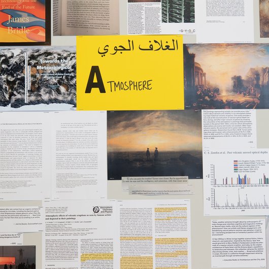 A collection of documents surround a yellow paper in the middle that has the word 'Atmosphere' written on it.