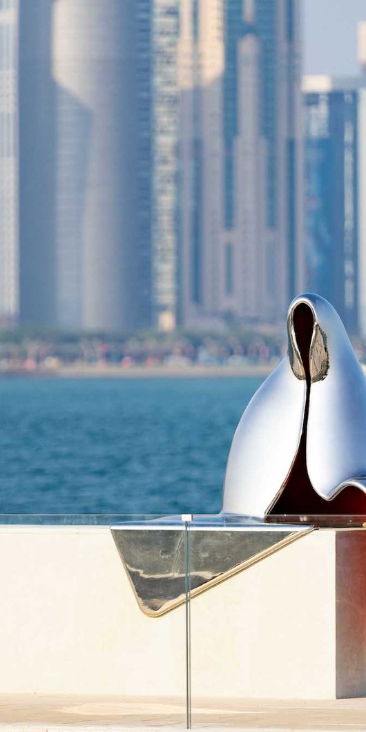 Abstract silver reflective sculpture of a Gulf woman on the waterfront