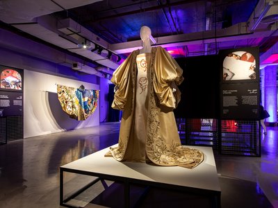 Gold dress with a cape in an exhibition display
