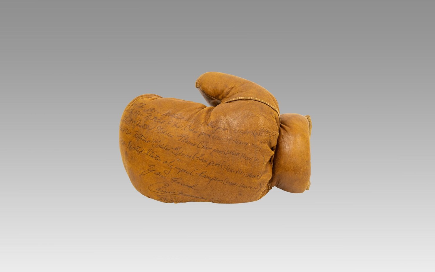 Boxing glove (left hand), 1960 Signed by Cassius Clay (Muhammad Ali)