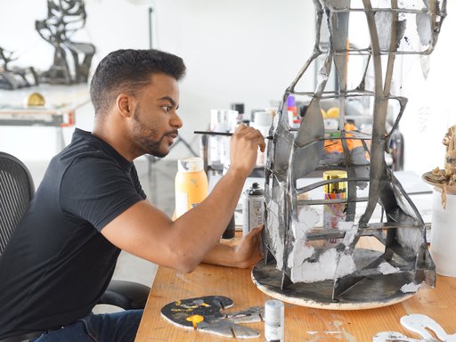 Artist in residence Mohammed Faraj Al-Suwaidi working in his studio at the Fire Station.