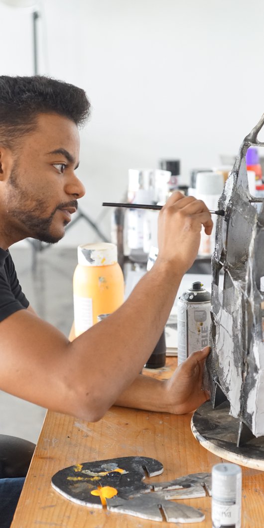 Artist in residence Mohammed Faraj Al-Suwaidi working in his studio at the Fire Station.