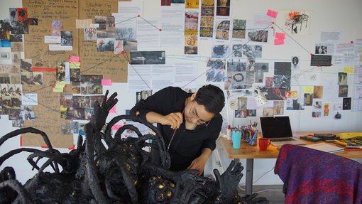 Nourbanu Hijazi working in her studio at the Fire Station.