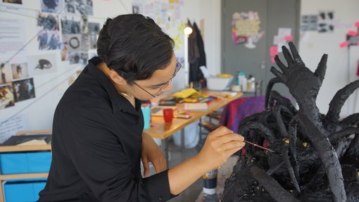 Artist Nourbanu Hijazi working in her studio at the Fire Station.