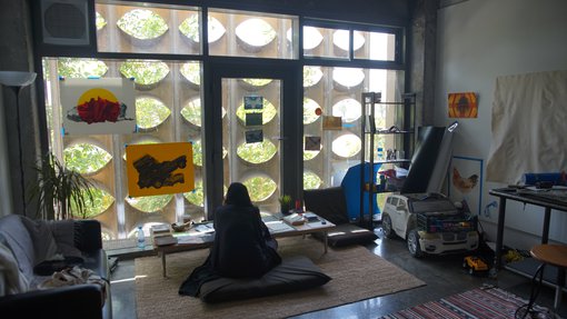 Artist Sara Al-Fadaaq working in her studio at the Fire Station.