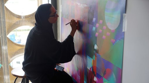 Artist in residence Shaikha Al-Hardan working in her studio.