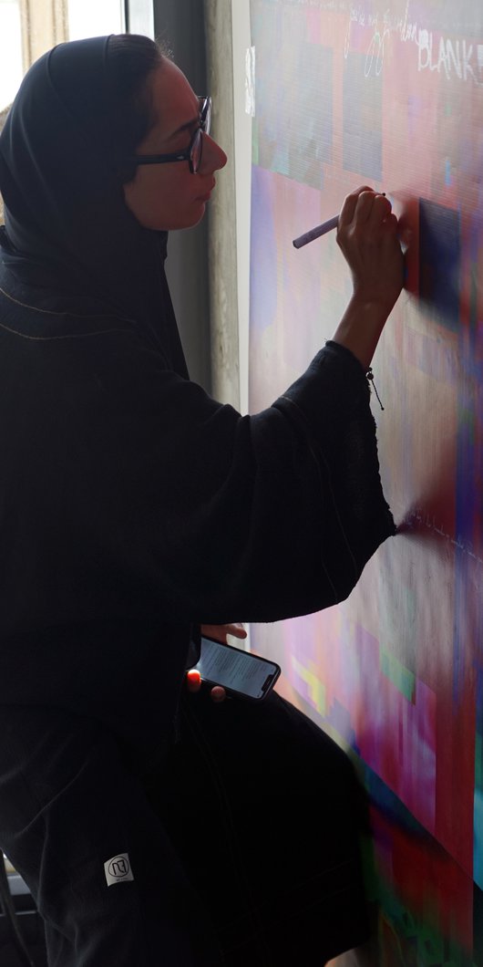 Artist in residence Shaikha Al-Hardan working in her studio.