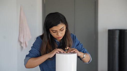 Sidra Zubairi working in her studio.