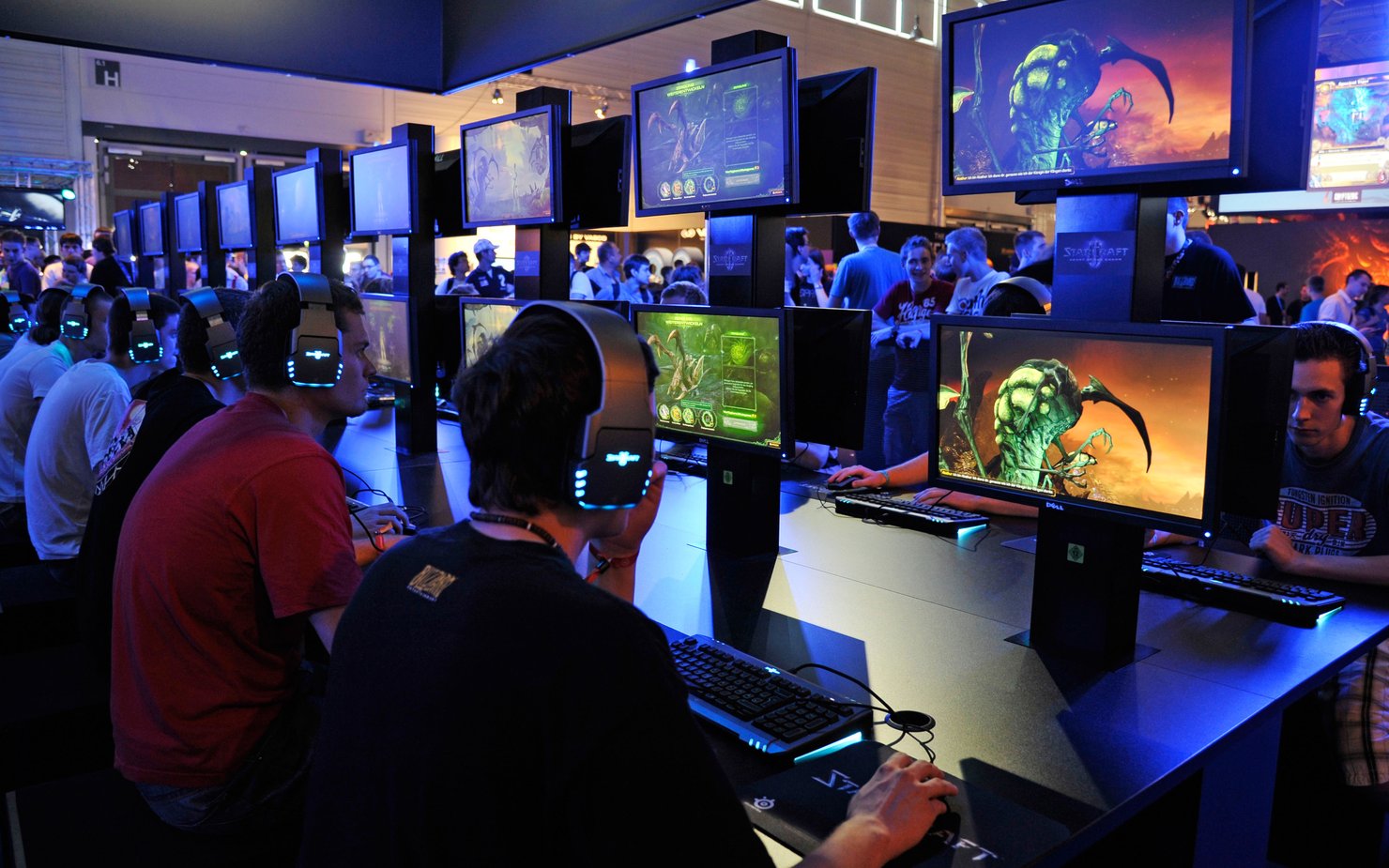 Teenagers play the latest version of Starcraft at the Gamescom convention in Cologne, Germany.