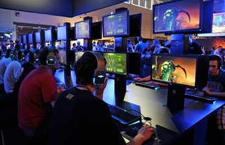 Teenagers play the latest version of Starcraft at the Gamescom convention in Cologne, Germany.