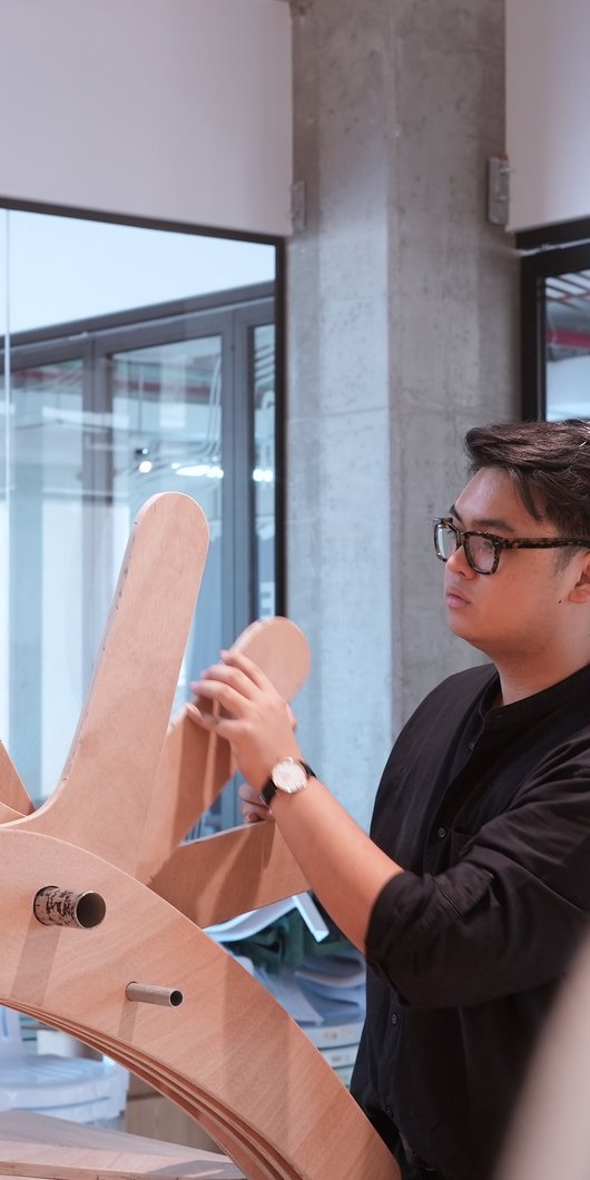 Man working on a wooden prototype