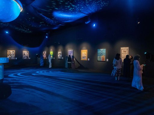 People walking in a blue themed room