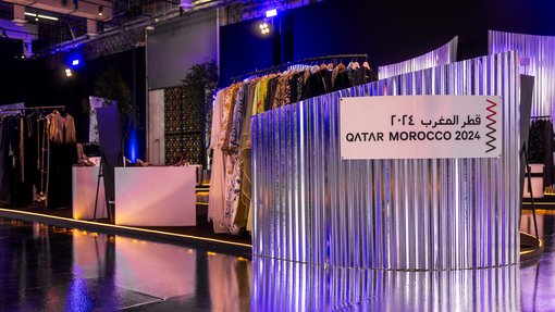 Booth with metallic borders and a sign that says Qatar Morocco