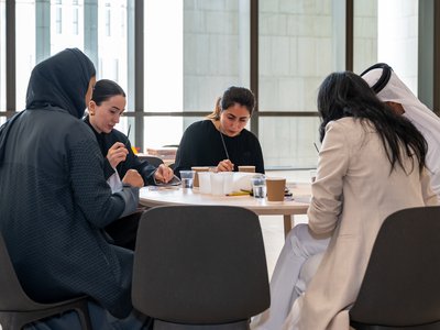 Group of adults sitting in one table doing crafts