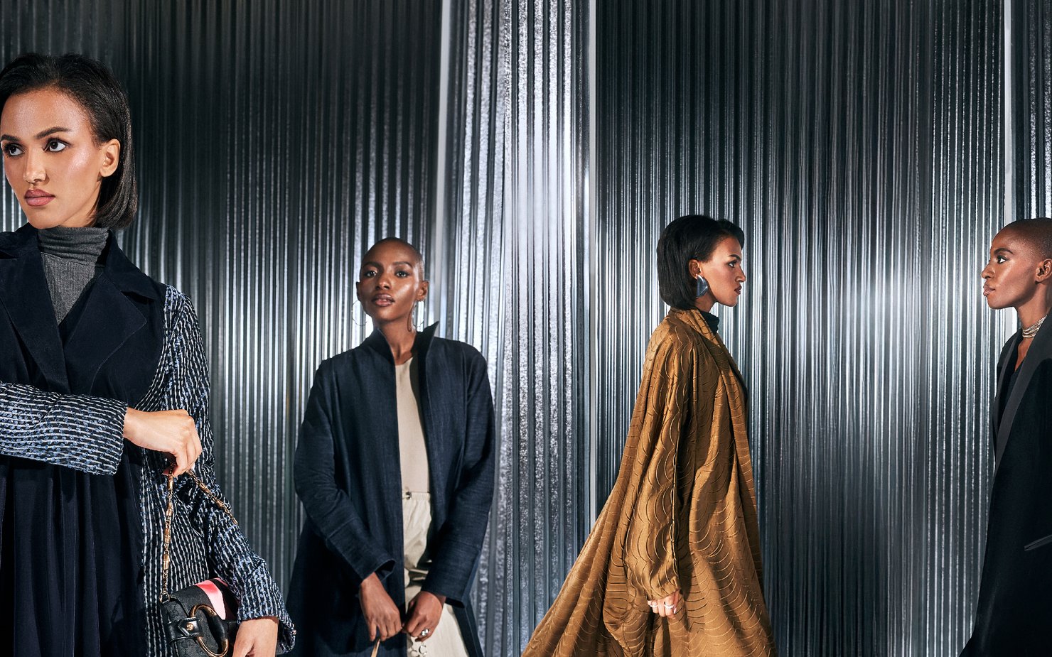Group of models against steel background