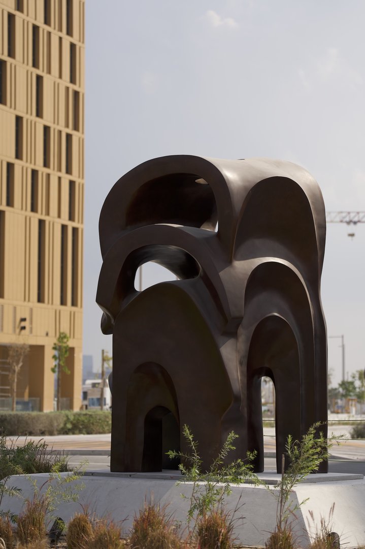 Dark brown large sculpture of arches placed on top of each other