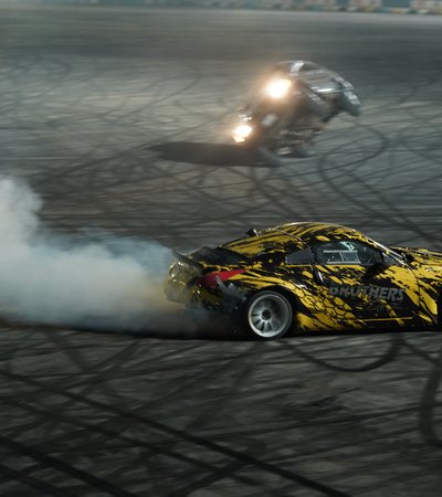 Two race cars free-style drifting in a circut