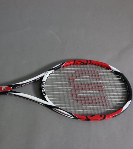 A black, red and white Wilson racquet signed by renowned tennis player Roger Federer.