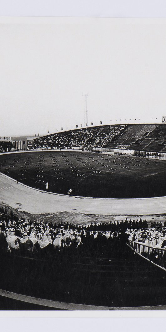 Black and white image of a stadium packed with spectators.