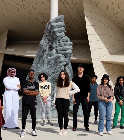 Teens standing in front of the National Museum of Qatar