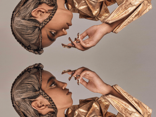 Mirror of a model wearing gold jacket and couture braids