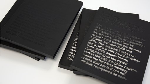 Black books stacked on top of each other with negative silkscreened text