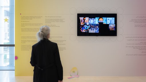 woman watching TV on a colorful wall