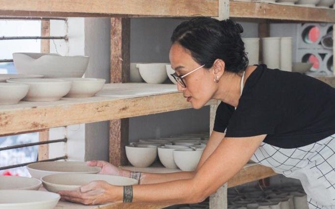 artist holding pottery