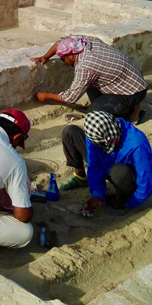 Four archaeologists excavating the remains of Al Shamali houses