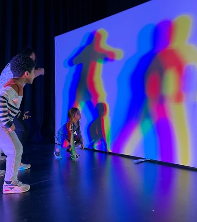 Children playing with LED lights to create shadows