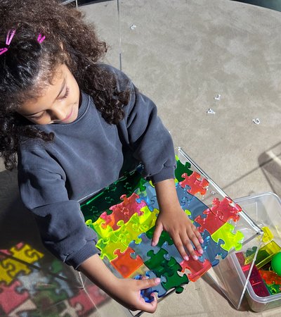 Girl playing with puzzle pieces