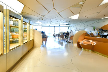 Groups of people sitting at tables, eating and drinking at the Desert Rose cafe National Museum of Qatar