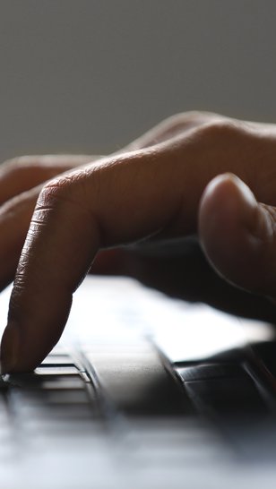 A close-up view of a hand typing on a keyboard