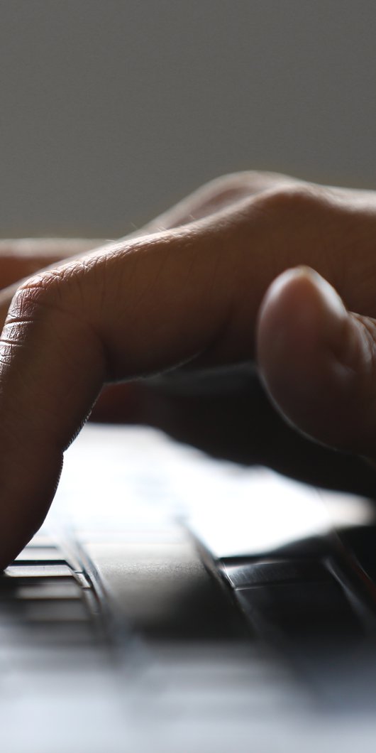 A close-up view of a hand typing on a keyboard