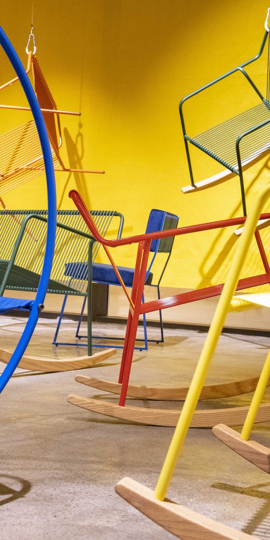 Interior view, Studio 7, colourful display of modern metal chairs