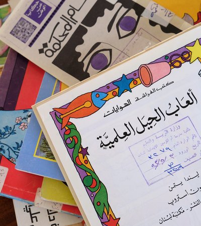 A pile of colourful vintage Arabic school books in Liwan's library.