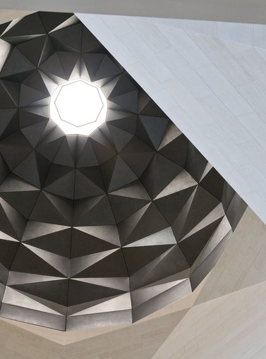 A view of MIA's dome-like ceiling with intricate architectural designs