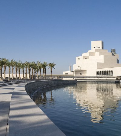 A wide-angled shot showing the exterior of MIA and surrounding palm trees of the MIA Park