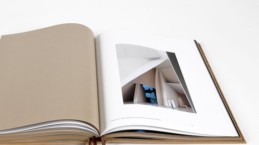 Open page book displaying a close up shot of the National Museum of Qatar interior entrance