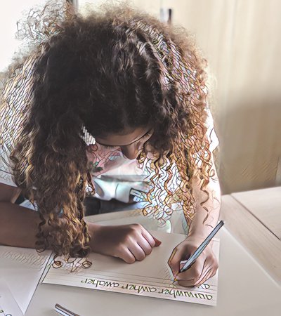 Close-up of a little girl writing on a paper