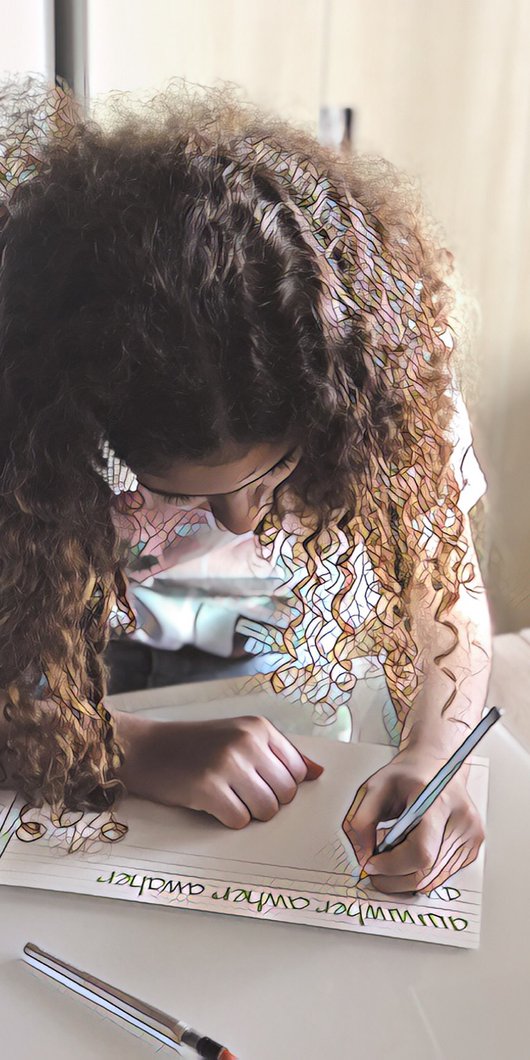 Close-up of a little girl writing on a paper