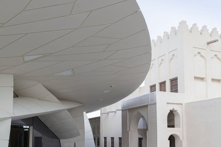 A close view of NMoQ's disks with the sculpted arches of the Old Palace visible in the background