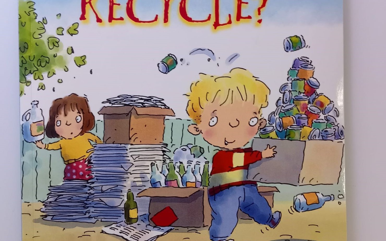 Storybook illustration depicting two children cleaning up with the title "Why should I recycle?"