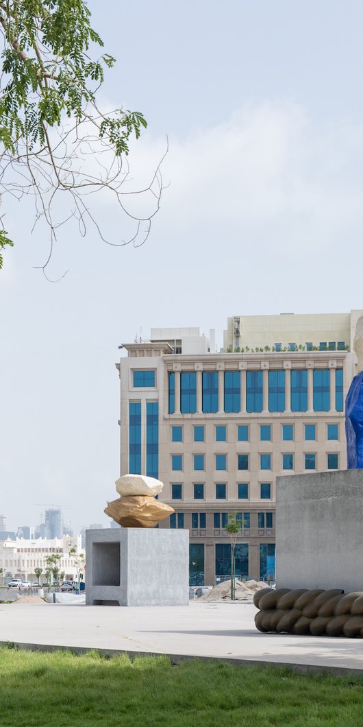 two large sculptures in blue and grey with ropes wrapped around