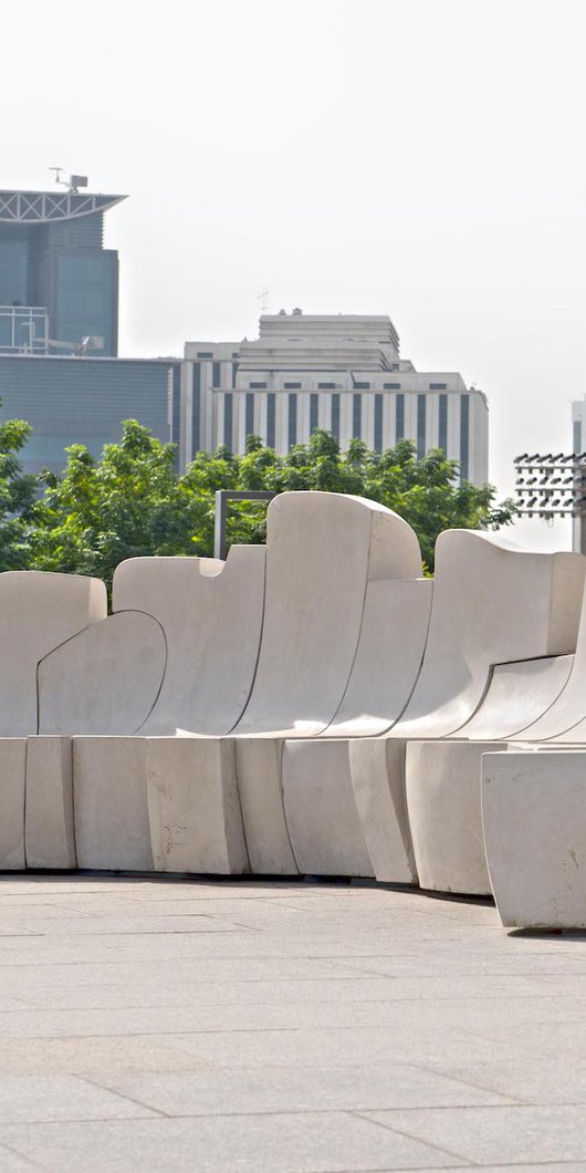 Bench by Saloua Raouda Choucair against a city background