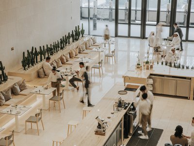 Viewed from above, a modern café interior with customers and staff.