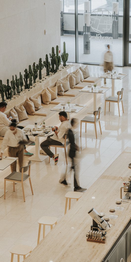 Viewed from above, a modern café interior with customers and staff.