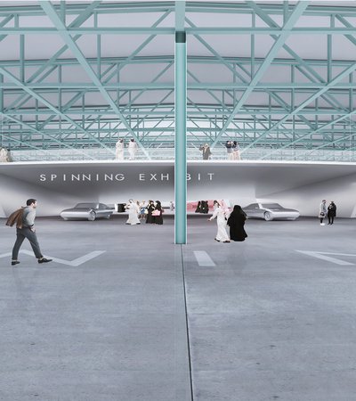 Rendering interior of the Qatar Auto Museum depicting animated people and cars in motion