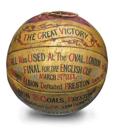 A golden coloured football with text that reads 'This ball was used at the Oval, London, in the final for the English Cup, March 24th 1888.